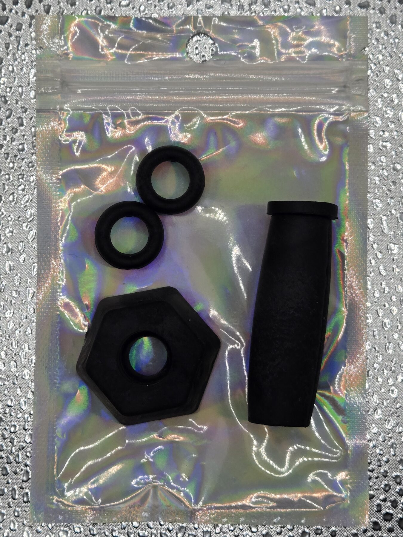 Complete Long Guard holographic resealable pouch with guard, Plug, Base, and two Nuts visible